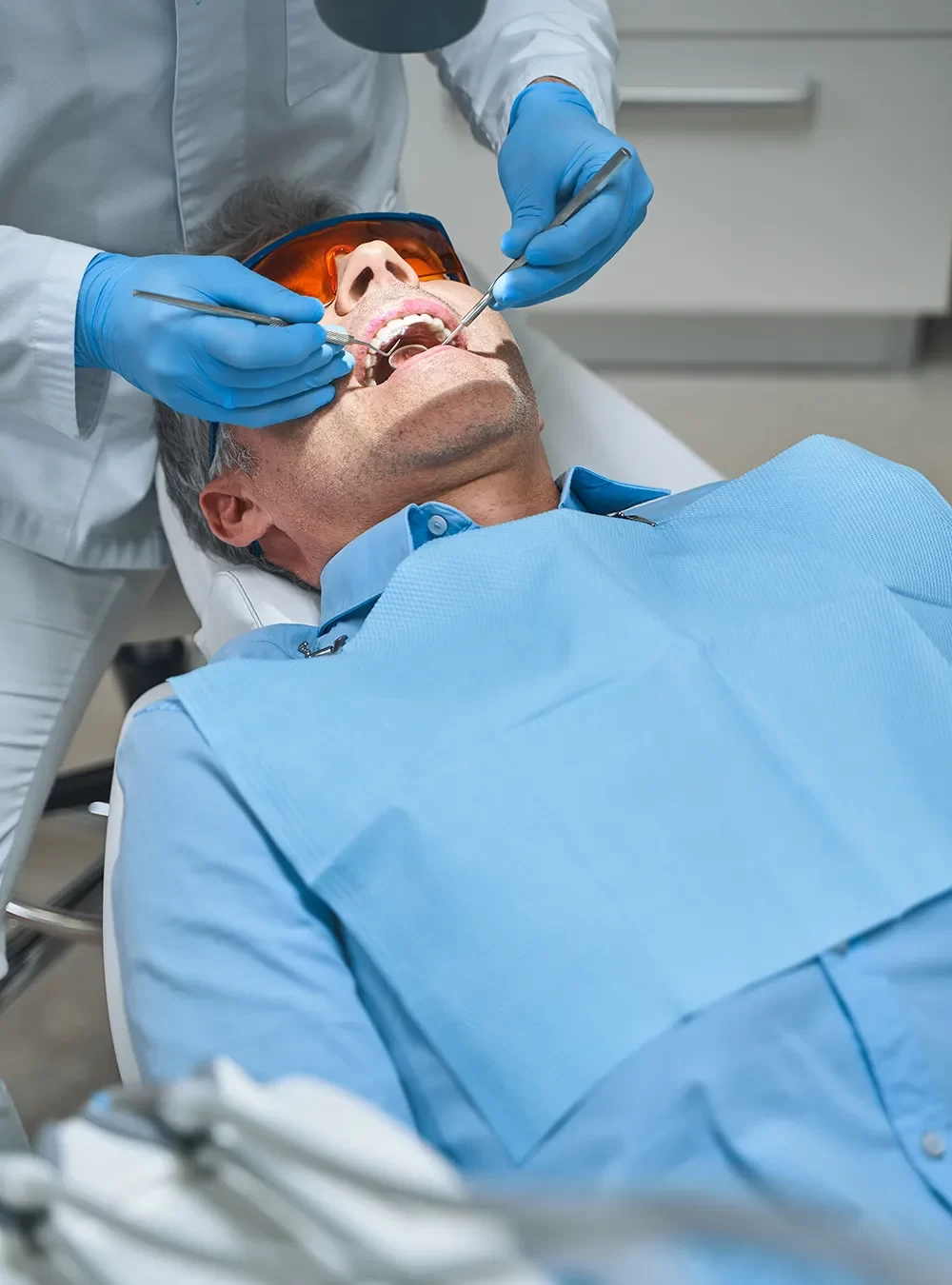 Happy patient in the dental chair receiving care at onyx clinic.