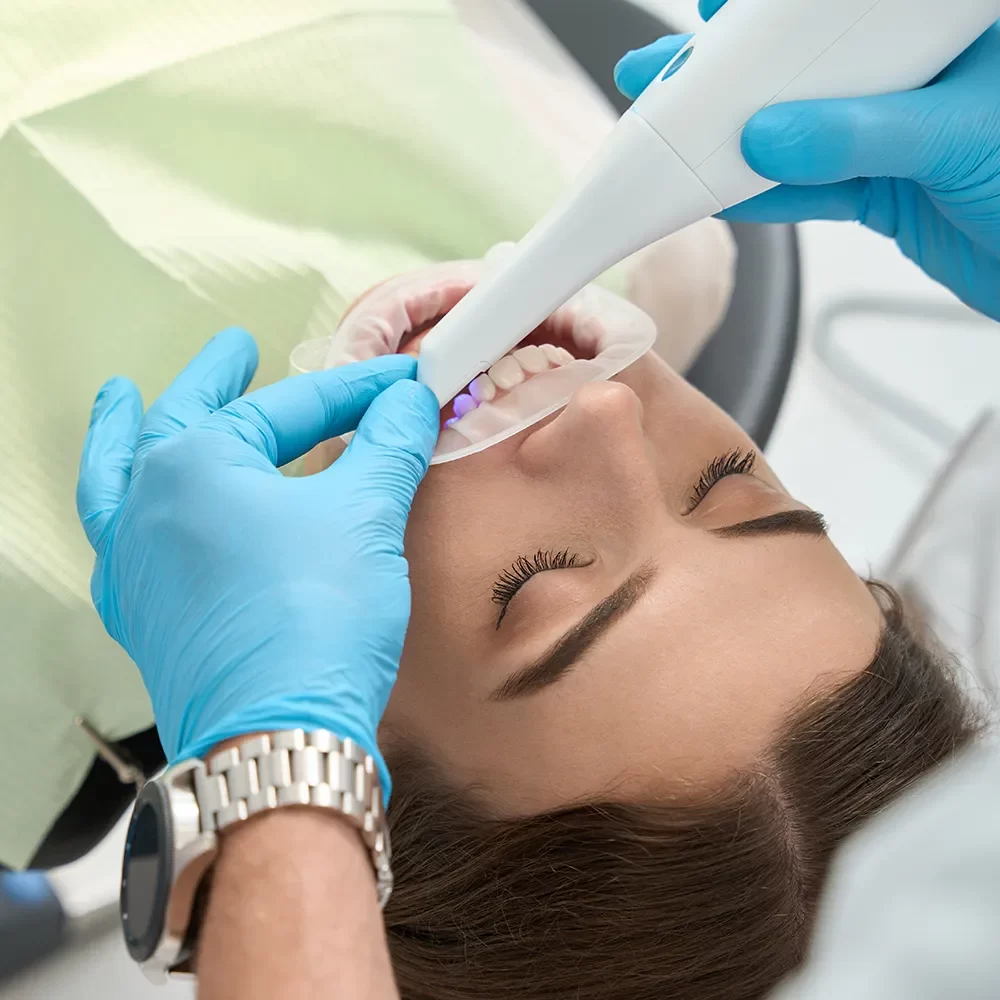 Happy patient in the dental chair receiving care.