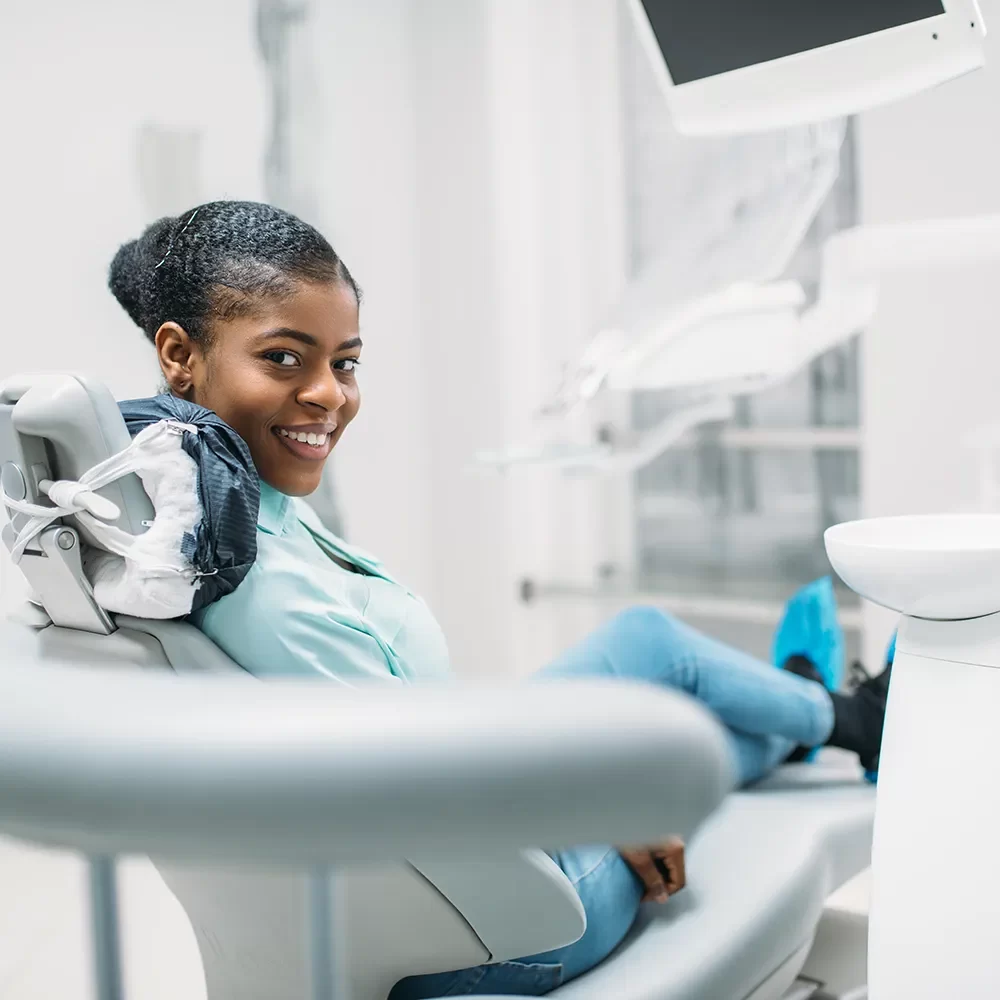 Satisfied patient sitting in the dental chair at Onyx Dental Clinic.