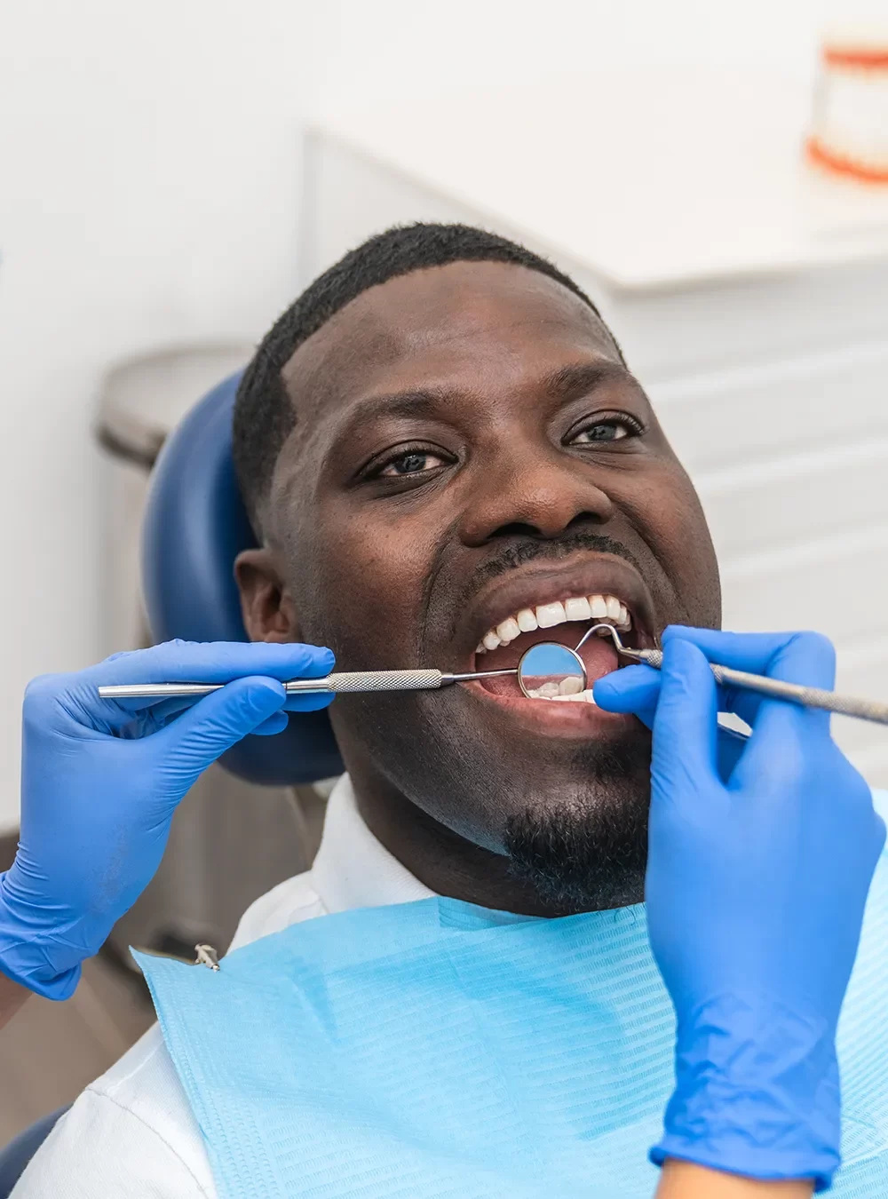 Dentist reviewing a personalized treatment plan with a patient during a dental exam under CDCP.