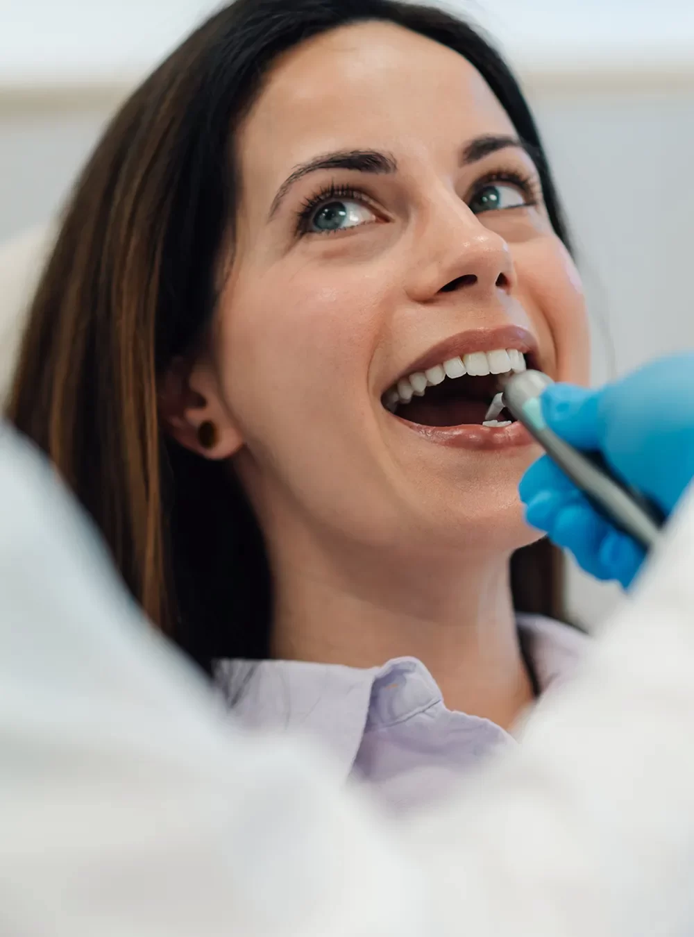 Dentist examining a patient, discussing treatment options, and explaining a personalized care plan under CDCP coverage.