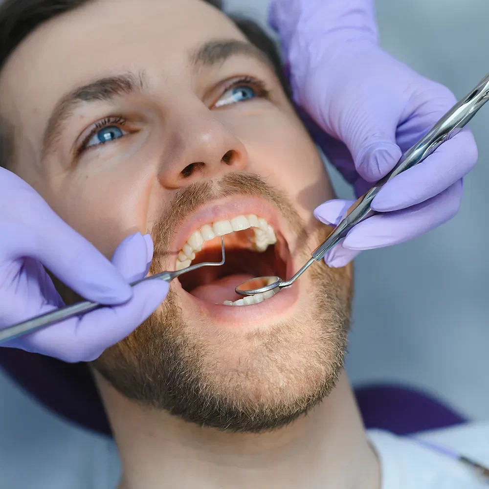 checking patient tooth by professional dentist in onyx dentistry
