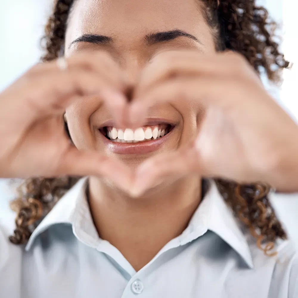 Confident smile showing white, straight teeth following dental implant procedure