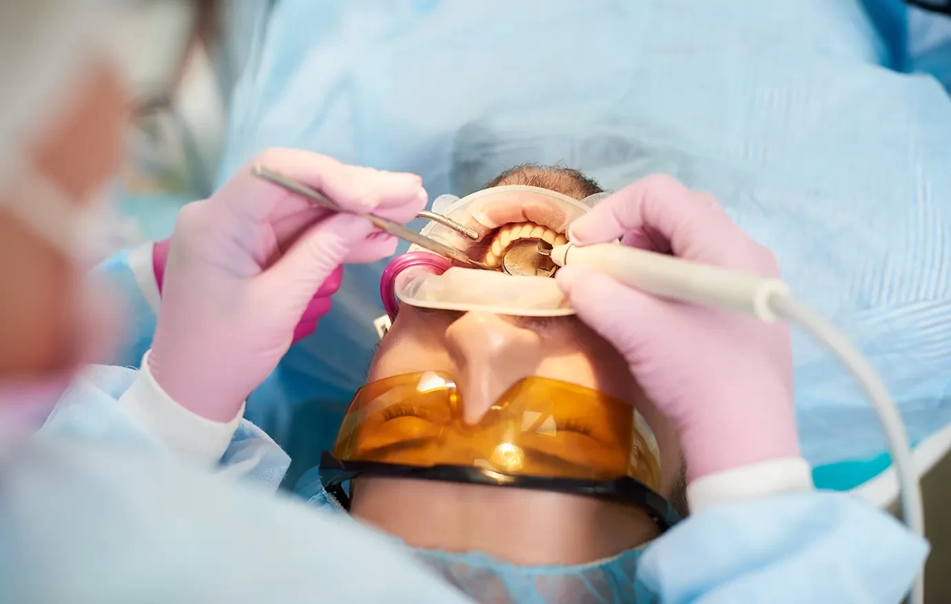 Patient receiving dental implant for restored function and appearance onyx dentistry