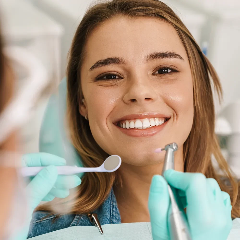 Smiling patient satisfied with scaling and root planing at Onyx Dental Clinic, Canada.