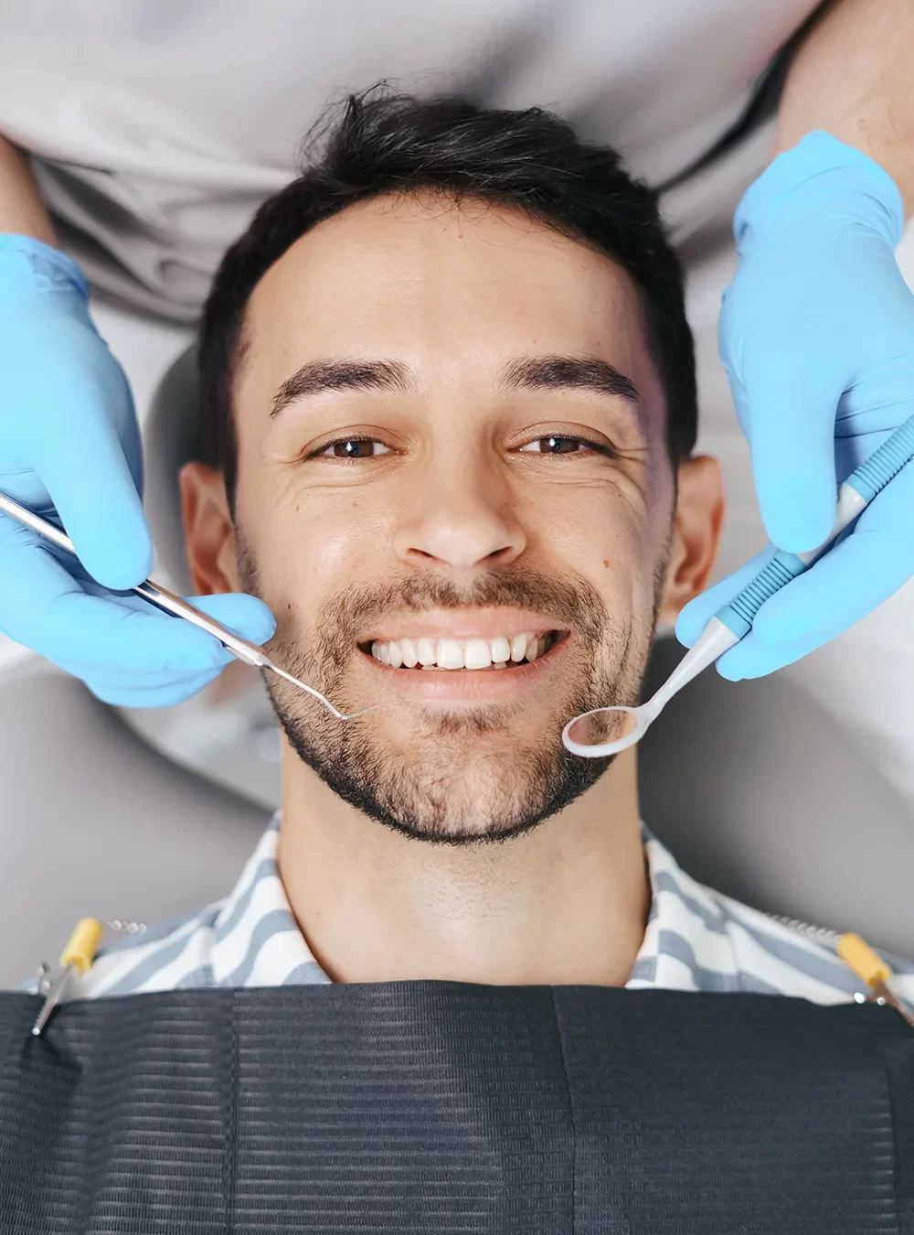 Happy patient in Canada in the dental chair receiving care.